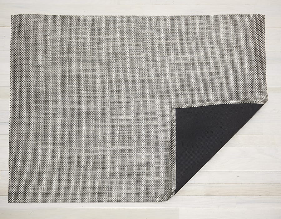 a rectangular woven floor mat made of eco friendly yarn in a soft grey mixed with white like the colour of an oyster shell