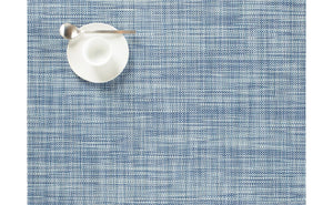 a rectangular, basket weave, woven placement made of eco friendly vinyl in chambray blue