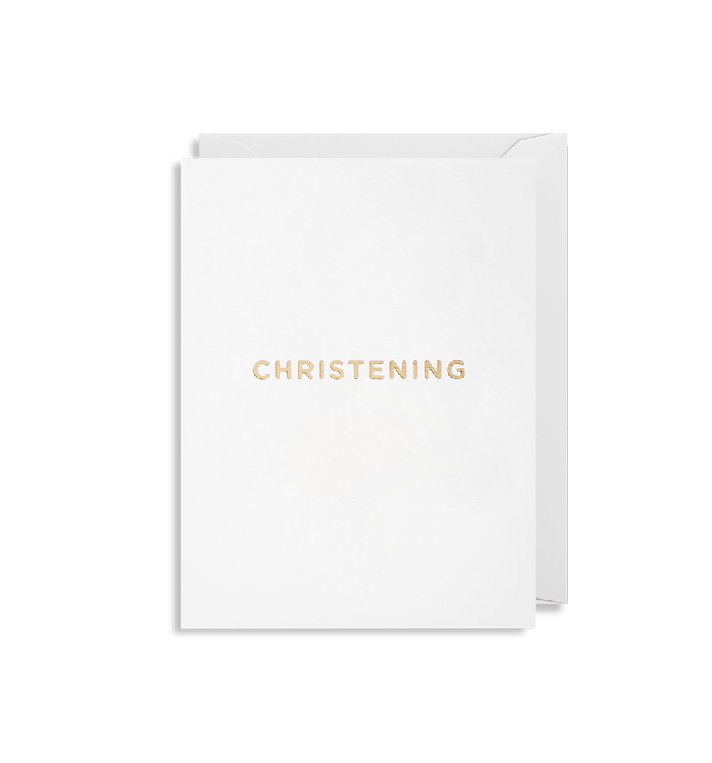 White card that reads "Christening" in rose gold letters