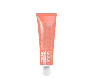 Compagnie de Provence Pink Grapefruit hand cream in a melon coloured 30mL tube with bold, modern white lettering.