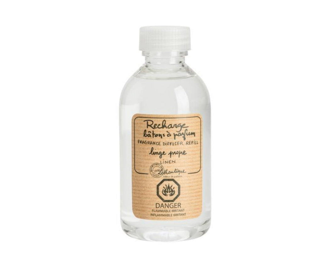 A clear, plastic bottle of Linen scented diffuser refill liquid, with a beige label printed with the words "Rechard batons a parfum, fragrance diffuser refill, linge propre, linen," the Lothantique logo and a danger flammable symbol