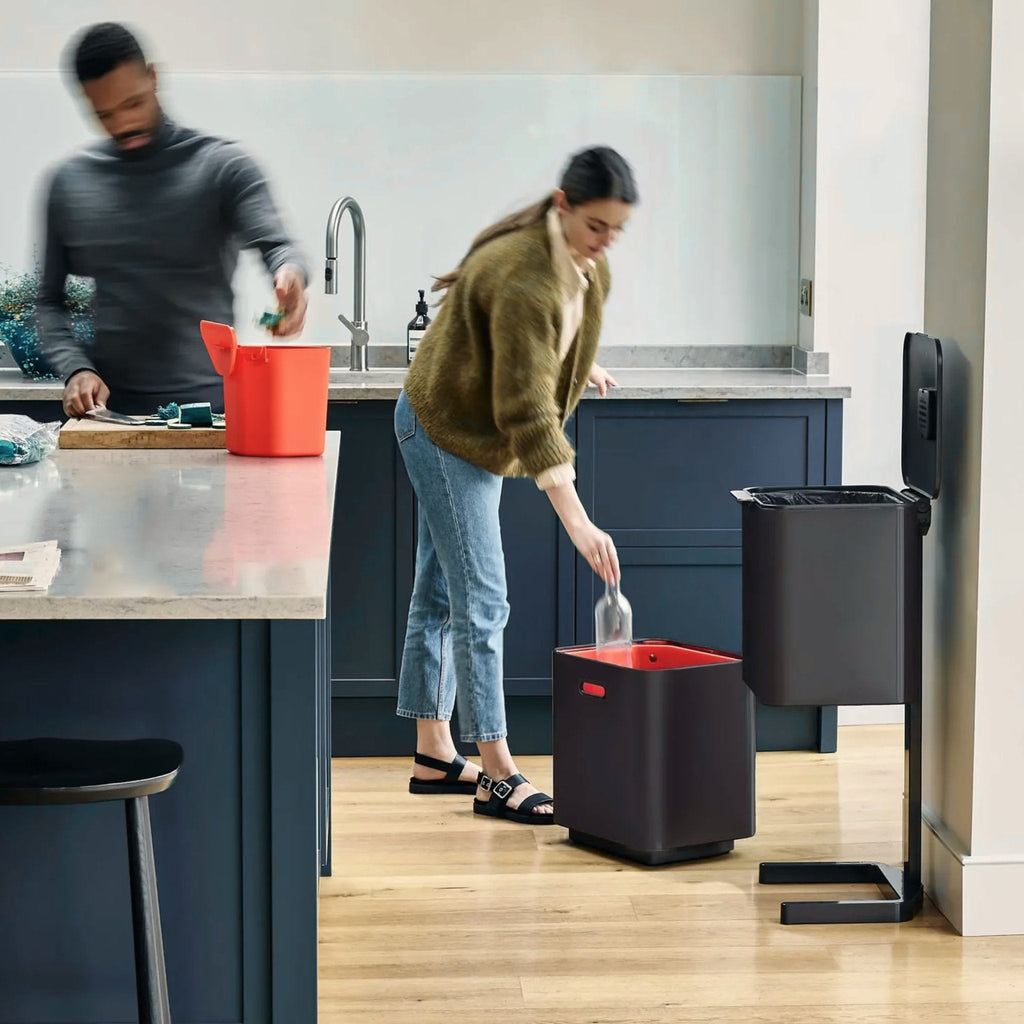 Joseph Joseph Totem waste bin, with recycling, garbage and compost comparments in a modern blue and white kitchen