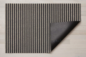 A dark grey and light grey thin striped rectangular floor mat backed with black commercial rubber, mat made of eco friendly looped vinyl yarns