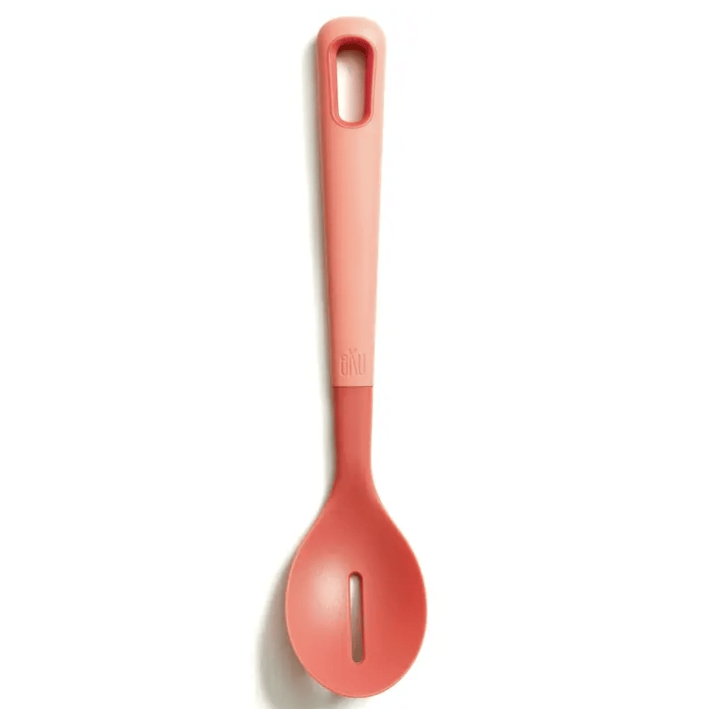 A watermelon pink nylon slotted cooking spoon on a white background, featuring a soft-touch, thick handle for a comfortable grip. Perfect for chefs and home cooks, this ergonomic kitchen utensil is ideal for stirring, mixing, and serving.