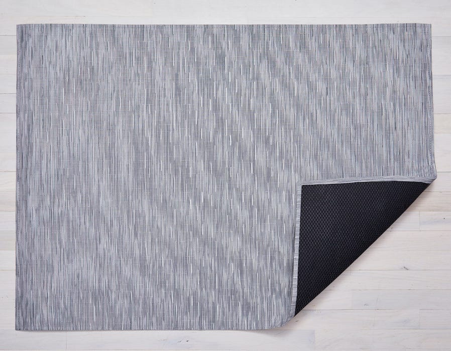 a woven floor mat made of eco friendly vinyl in shades of medium cool toned grey