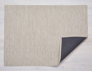 A rectangular woven floor mat made of eco friendly vinyl yarn in a soft oat colour