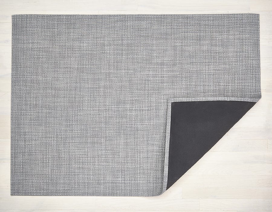 a rectangular basket woven floor mat made of eco friendly vinyl yarn in shades of grey and white