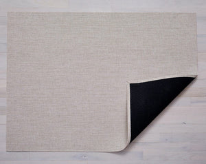 a rectangular woven floor mat made of eco friendly vinyl yarn in a natural colour like the colour of raw canvas