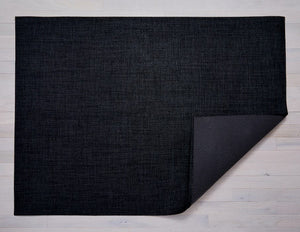 a rectangular woven floor mat in soft black made of eco friendly vinyl yarn