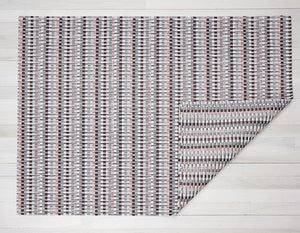 A rectangular, heddle style woven floor mat made of eco friendly vinyl yarn in taype, coral, pale pink, and grey