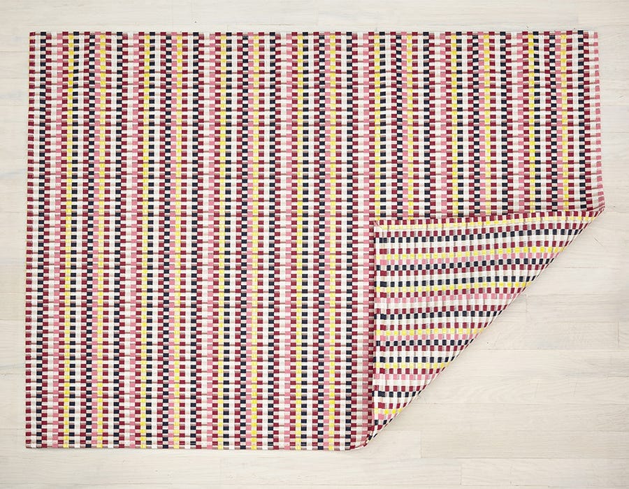 a heddle style woven mat made of eco friendly vinyl yarn in dark pink, bubblegumpink, white, orange, yellow, and navy