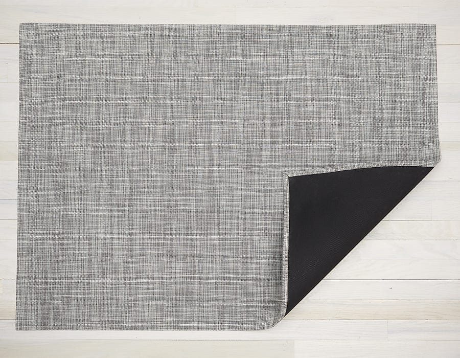 a rectangular woven floor mat made of eco friendly vinyl yarn in white and silver, at a distance looks like a soft grey