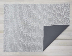 a rectangular silver woven floor mat with a subtle geometric pattern made of eco friendly vinyl