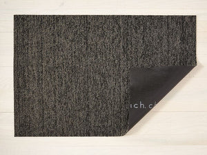 a black and tan heathered rectangular floor mat made of eco friendly looped vinyl yarns, with black commercial rubber backing
