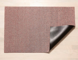 a heathered, blush pink rectangular floor mat made of eco friendly looped vinyl yarns backed with black commercial rubber