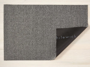 a light, fog grey heathered rectangular floor mat made of eco friendly looped vinyl yarns, backed with black commercial rubber