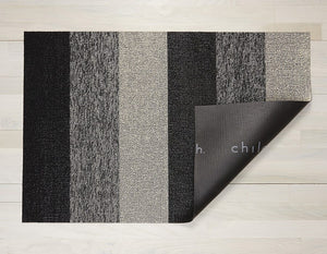 a monochromatic, wide-striped, rectangular floor mat made of eco friendly looped vinyl yarn, backed with black commercial rubber