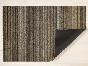 A skinny stripe designed rectangular floor mat in shades of brown, made of eco friendly looped vinyl yarn, backed with black commercial rubber