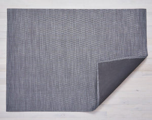 a pewter coloured rectangular floor mat made of woven vinyl backed with black non slip material