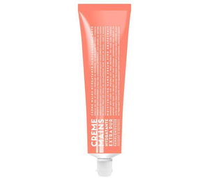 Compagnie de Provence Pink Grapefruit hand cream in a melon coloured 100mL tube with bold, modern white lettering.