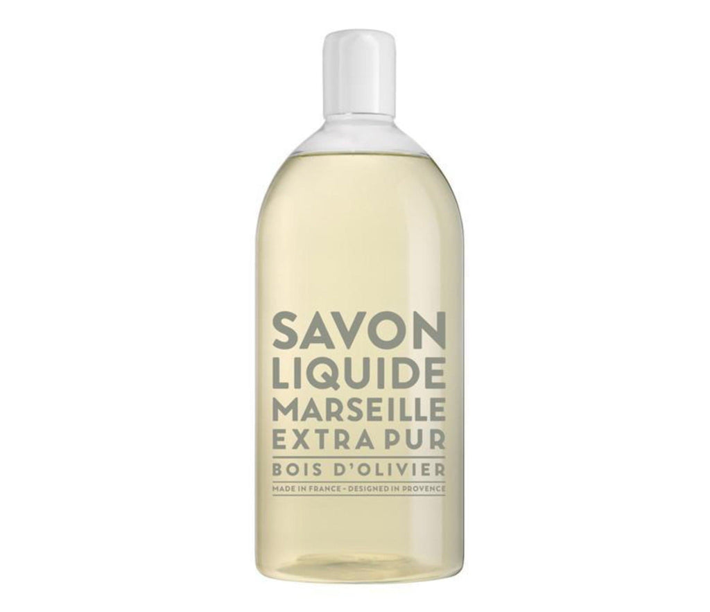 Compagnie de Provence Olive Wood liquid soap in a 1L clear plastic refill bottle with modern grey block letters