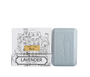 A bar of lavender scented soap in black and white packaging featuring a simple line drawing of French style buildings.