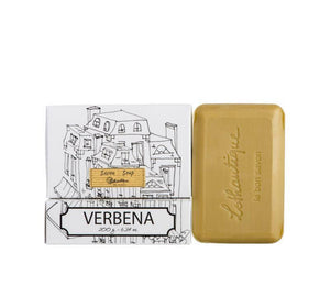 A taupe coloured bar of verbena scented soap in black and white packaging, featuring a simple line drawing of French style buildings.