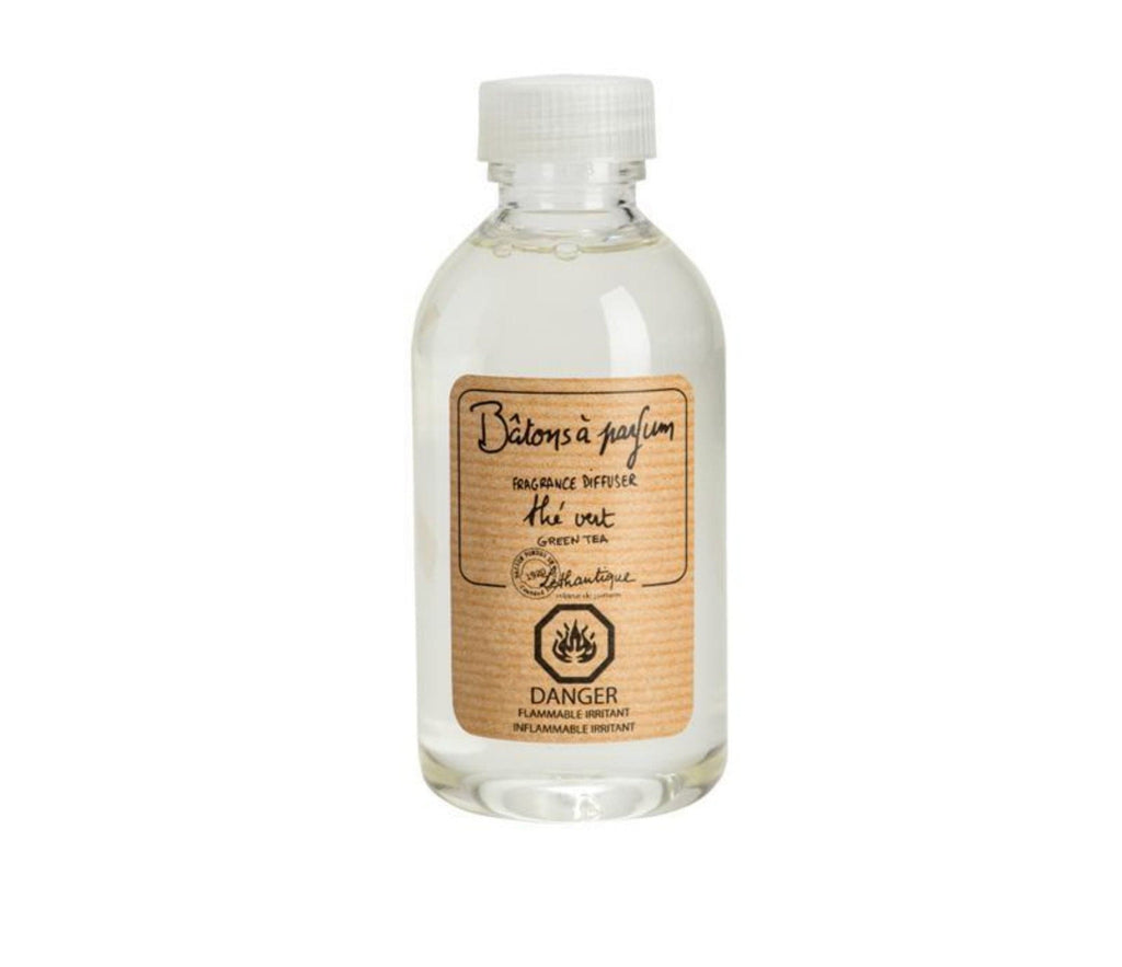 A clear, plastic bottle of Green Tea scented diffuser refill liquid, with a beige label printed with the words "Rechard batons a parfum, fragrance diffuser refill, the vert, green tea," the Lothantique logo and a danger flammable symbol