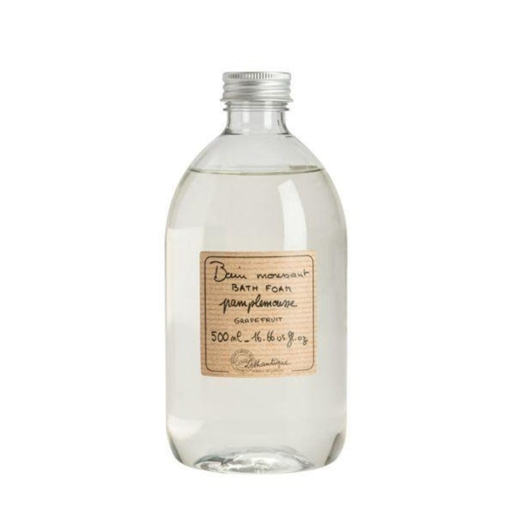 Clear plastic bottle of grapefruit scented foam bath. A striped beige label is printed with the words "bain moussant, bath foam, pamplemousse, grapefruit, 500mL - 16.66 fl oz" and the Lothantique logo.