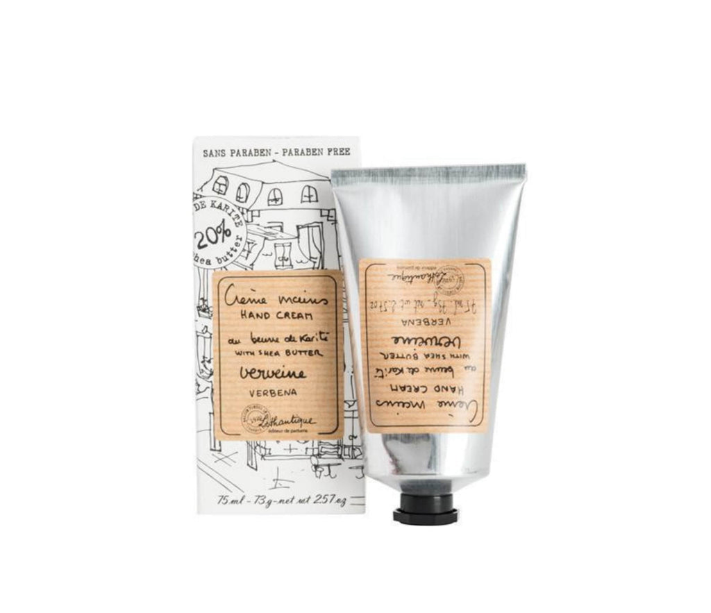 Verbena scented shea butter hand cream in a silver tube with a striped beige label printed with "creme mains, hand cream, beurre du karite, shea butter, verveine, verbena" and the Lothantique logo, to the left is a white box, with the same label and line drawings of French houses.
