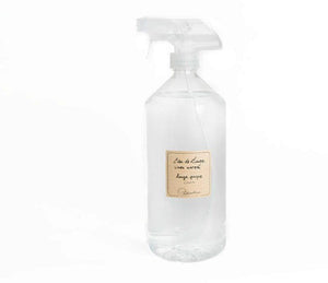 Linen scented linen water in a clear, plastic bottle with a spray nozzle. A striped, beige label is printed with "eau de linge, linen water, linge propre, linen" and the Lothantique logo.