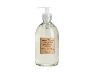 a clear plastic bottle of grapefruit scented French liquid soap with a white pump. A beige, subtly striped label is printed with the product description and Lothantique logo