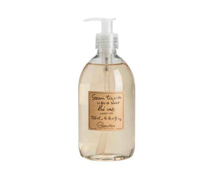 a clear plastic bottle of green tea scented French liquid soap with a white pump. A beige, subtly striped label is printed with the product description and Lothantique logo