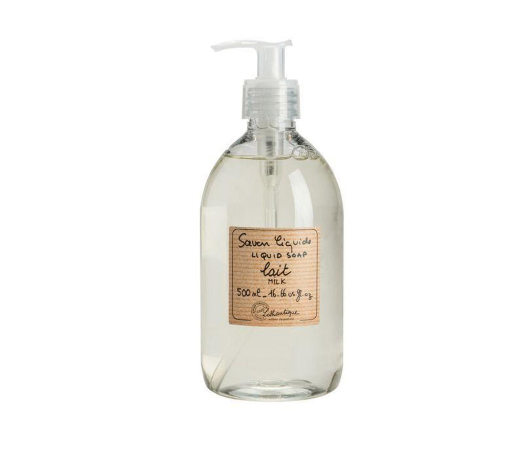 a clear plastic bottle of milk scented French liquid soap with a white pump. A beige, subtly striped label is printed with the product description and Lothantique logo